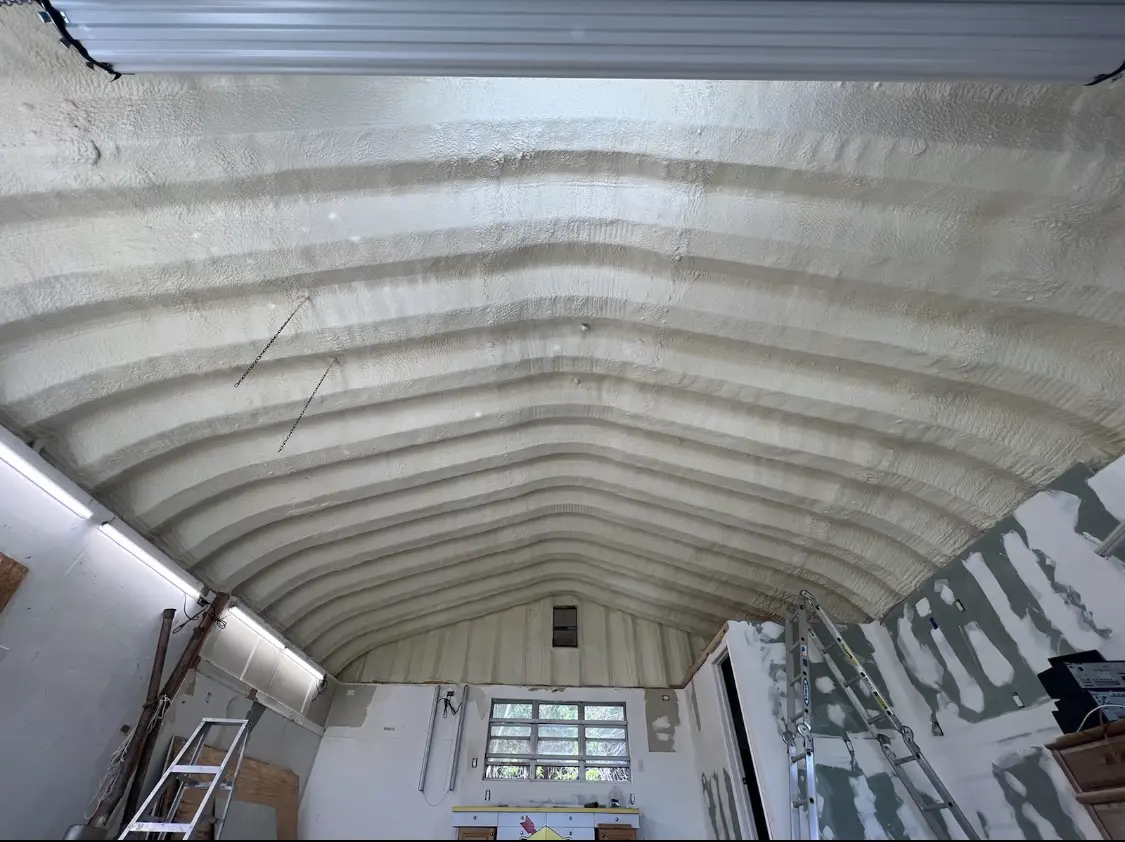 Spray polyurethane foam applied to the underside of a metal roof deck in Windsor Heights
